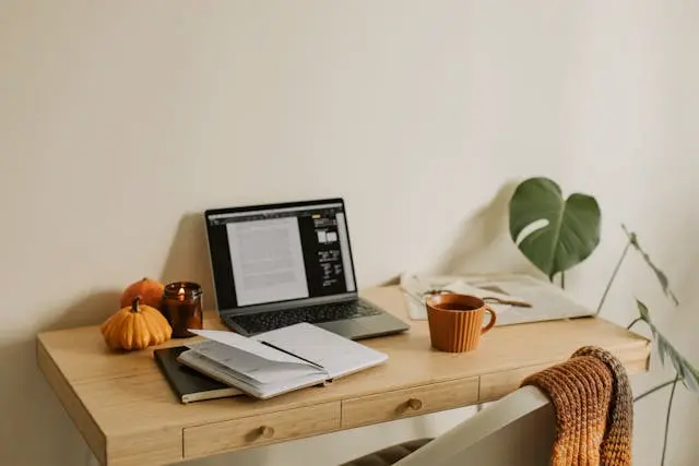 escritorio con laptop planta y taza de cafe